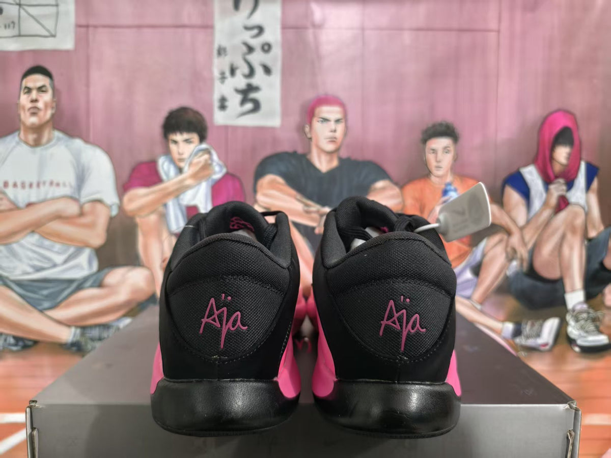 Rear view of black and pink Nike basketball sneakers showing padded collars and pink heel branding.