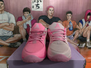 Front view of the mismatched pink and light pink Jordan sneakers showing perforated toe boxes, laces, tongue logos, and outsole details.