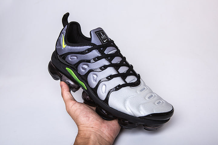 Single silver-gray, black, and green Nike TN-9 sneaker shown at an angle.