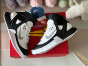 Pair of black-and-white kids' high-top sneakers displayed on a red box.