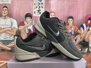 Angled view of the gray Nike sneakers showing the side Swoosh, layered midsole, and black outsole.