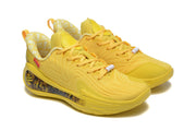 Angled view of the pair of yellow lace-up sneakers with tonal detailing and contrasting heel panels.