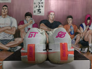 Rear view of white Nike basketball sneakers with pink heel branding and coral heel accents on a shoebox.