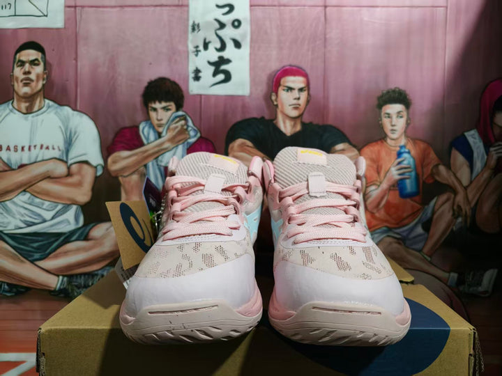 Front view of pink and white ASICS basketball shoes with pale blue side details