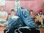 Pair of blue and silver Nike basketball sneakers displayed on a black shoebox, showing the patterned upper, laces and textured outsole.