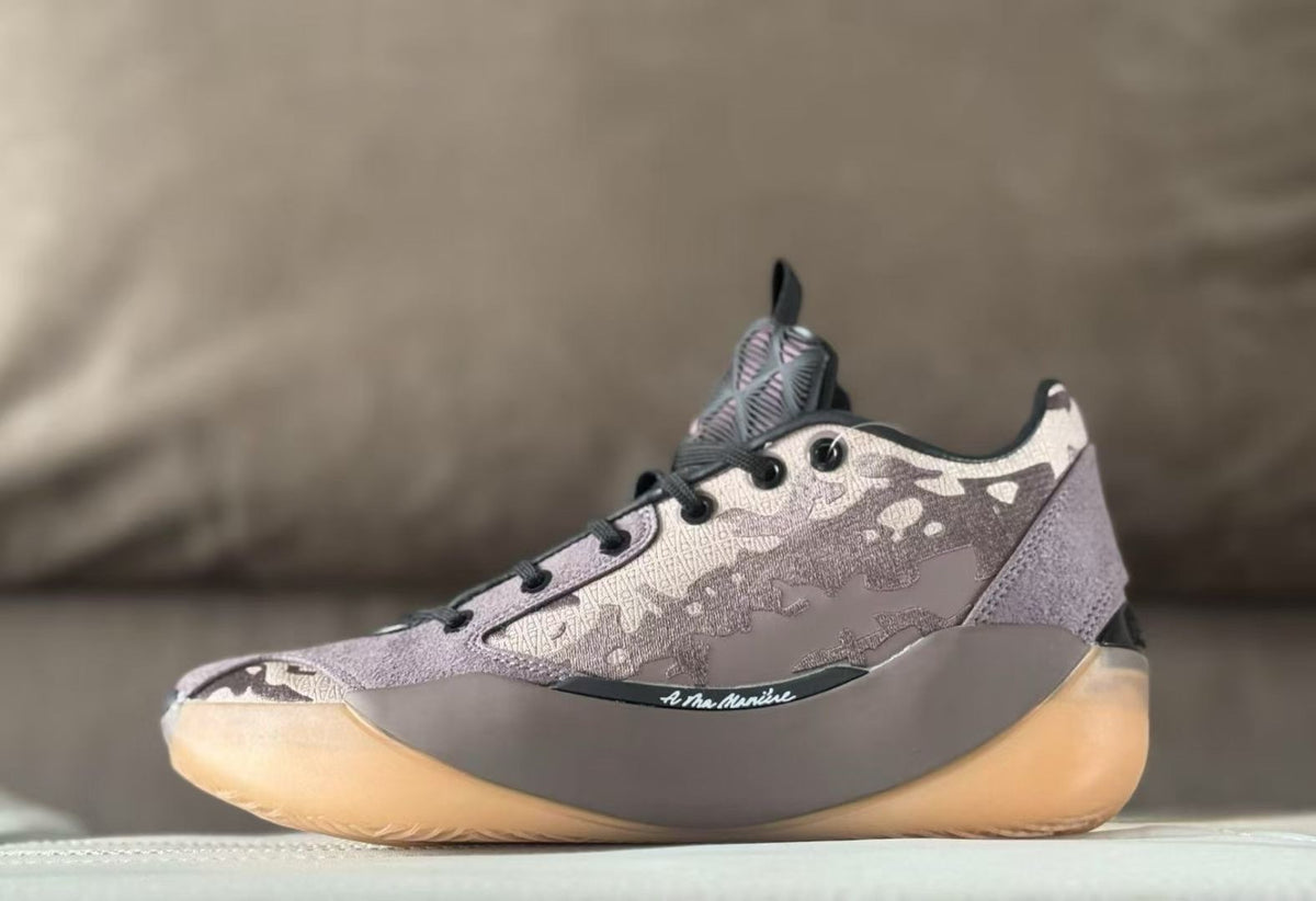 Side view of a mauve and gray Air Jordan 39 sneaker with a patterned upper and amber-colored outsole.