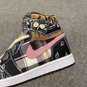 Close side view showing the pink Swoosh-style mark, plaid center panel, black paisley panels, and white midsole.