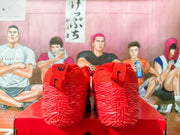 Rear view of red Nike basketball shoes with sculpted textured soles.