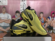 Yellow and black Nike basketball sneakers arranged in a side view, showing the Swoosh branding and patterned outsole.
