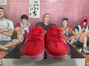 Front view of red Nike basketball sneakers with matching laces, dark Nike logos, and translucent outsoles.