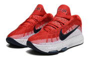 Pair of red and white Nike GT Hustle 3 shoes with dark Swoosh details.