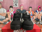 Front view of black and white Nike sneakers with black laces, padded tongues, and layered toe panels.