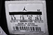 Close-up of a size label showing US 8.5, UK 7.5, EUR 42, CM 26.5, and style code 384664-123.