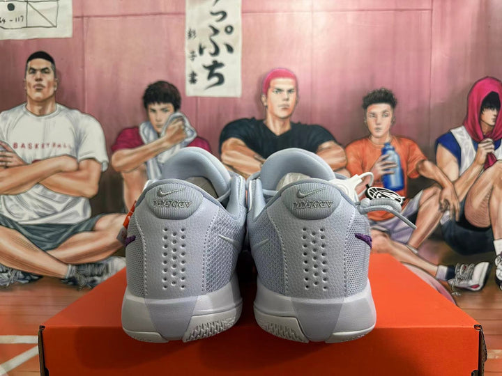 Rear view of gray Nike basketball shoes with purple accents