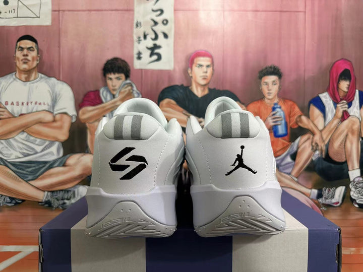 Heel view of white and grey basketball shoes with black logos