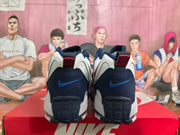 Rear view of the pair showing dark blue heel panels, blue Swoosh details, and red accents.