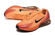 Close view of the orange Nike sneakers and their dotted gradient detailing.