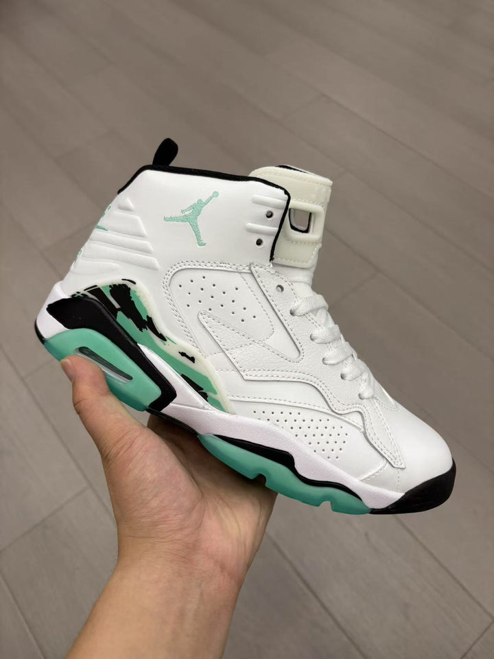 White and mint green Jordan high-top sneaker held in hand, showing the perforated side panel, black accents, layered overlays, and visible Jumpman logo.