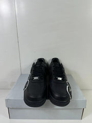 Front view of a pair of black low-top sneakers with perforated toe boxes, black laces, and metallic lace tags.