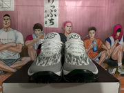 Front view of the pair showing the patterned toe boxes, lace panels, black outsoles, and tongue branding.