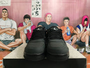 Front view of black lace-up Nike sneakers with mesh panels and Jumpman tongue logos.
