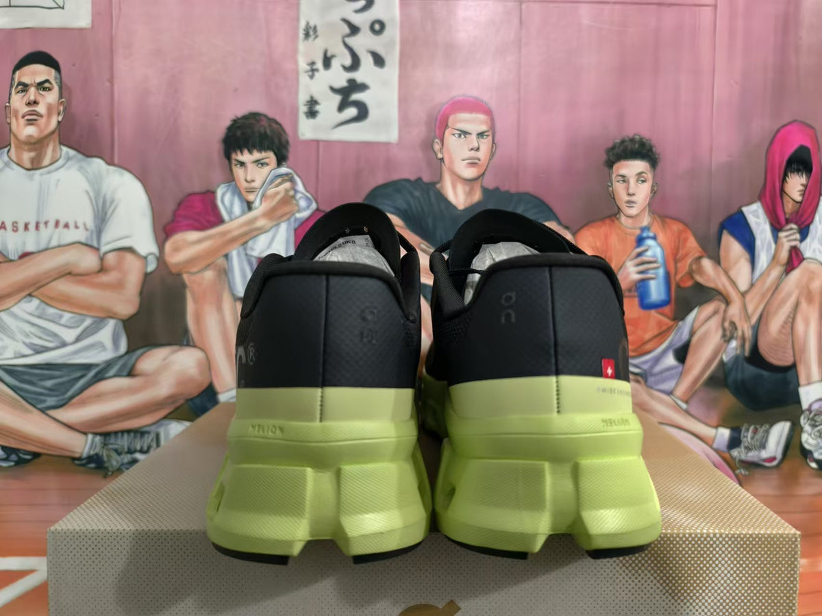 Rear view of black sneakers with lime-green soles