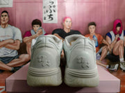 Rear view of the white sneakers showing textured heel panels