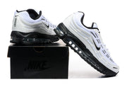 White and black Nike Air Max Plus 3 sneakers displayed on a black shoebox
