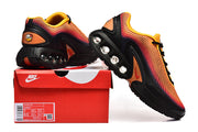 Nike Air Max DN sneakers in orange, pink, yellow, and black shown with a branded shoe box.