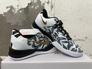 Pair of Nike Kobe shoes showing patterned uppers, gold accents, and heel design