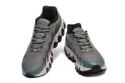 Front view of gray Nike Air Max DN sneakers with lace-up closures.