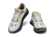 Front views of the On Cloudtilt Remix sneaker pair with pale uppers and black sculpted outsoles.