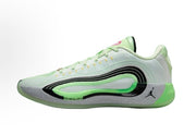 Side view of pale white and green Jordan Luka basketball sneakers with black detailing, a speckled gray midsole, and green outsole.