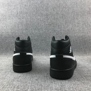 Rear view of a pair of black sneakers showing padded collars and contrasting white heel stripes.