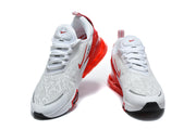 Front views of a pair of white Nike Air Max 270 Premium sneakers with red accents.