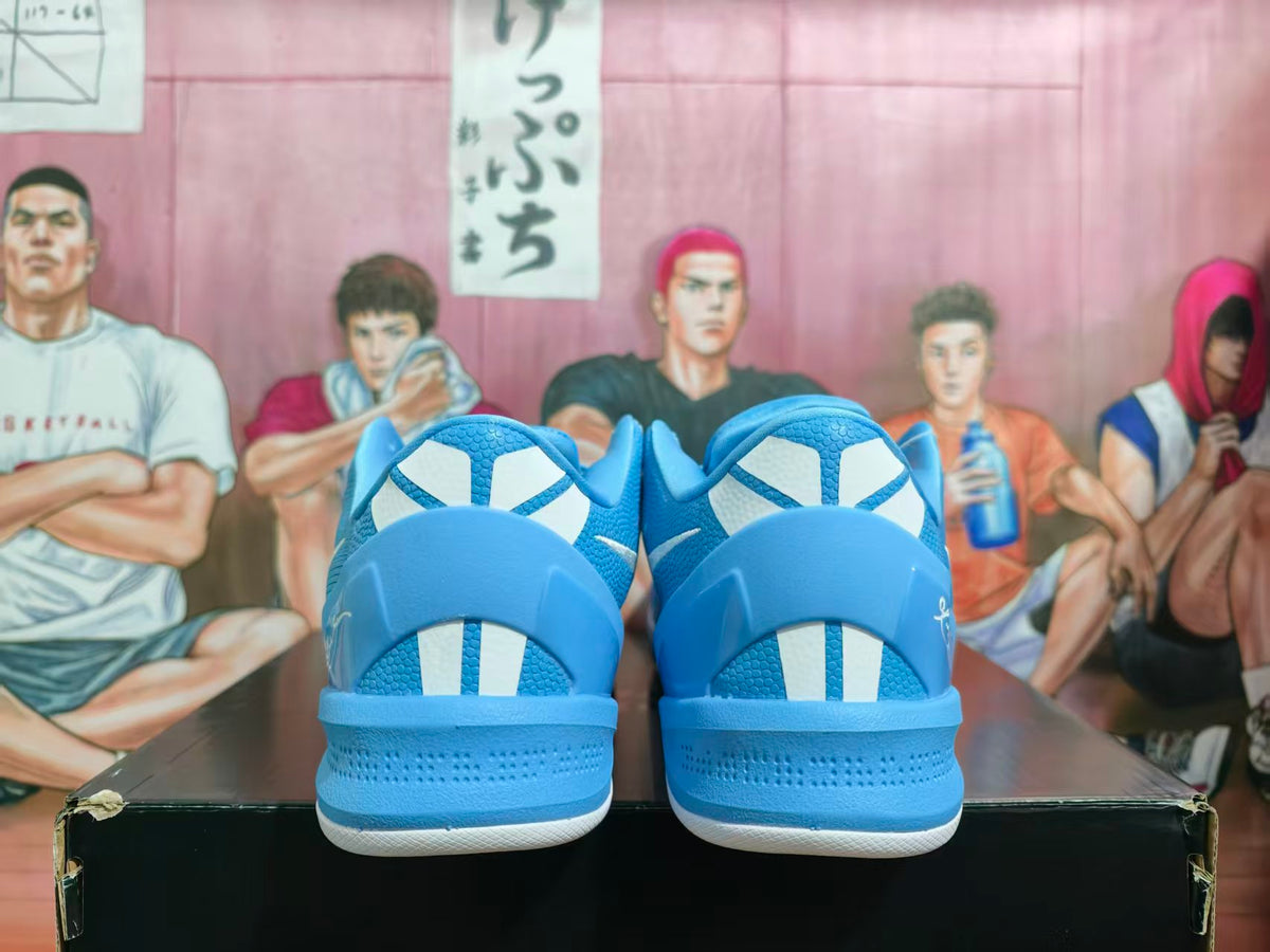 Rear view of royal blue Nike basketball sneakers showing the heel panels, white accents, and textured outsole edges.