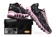 Pair of black and pink Nike Air Max DN8 sneakers displayed with a box label.