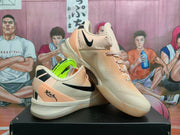 Angled view highlighting the Nike Kobe 8 Protro side branding, pale pink panels, and spare laces