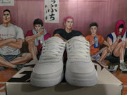 Front view showing the white laces, perforated toe boxes, and low-top sneaker shape.
