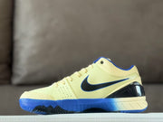 Opposite side profile showing the pale yellow textured upper, black Swoosh, blue sole and heel structure.