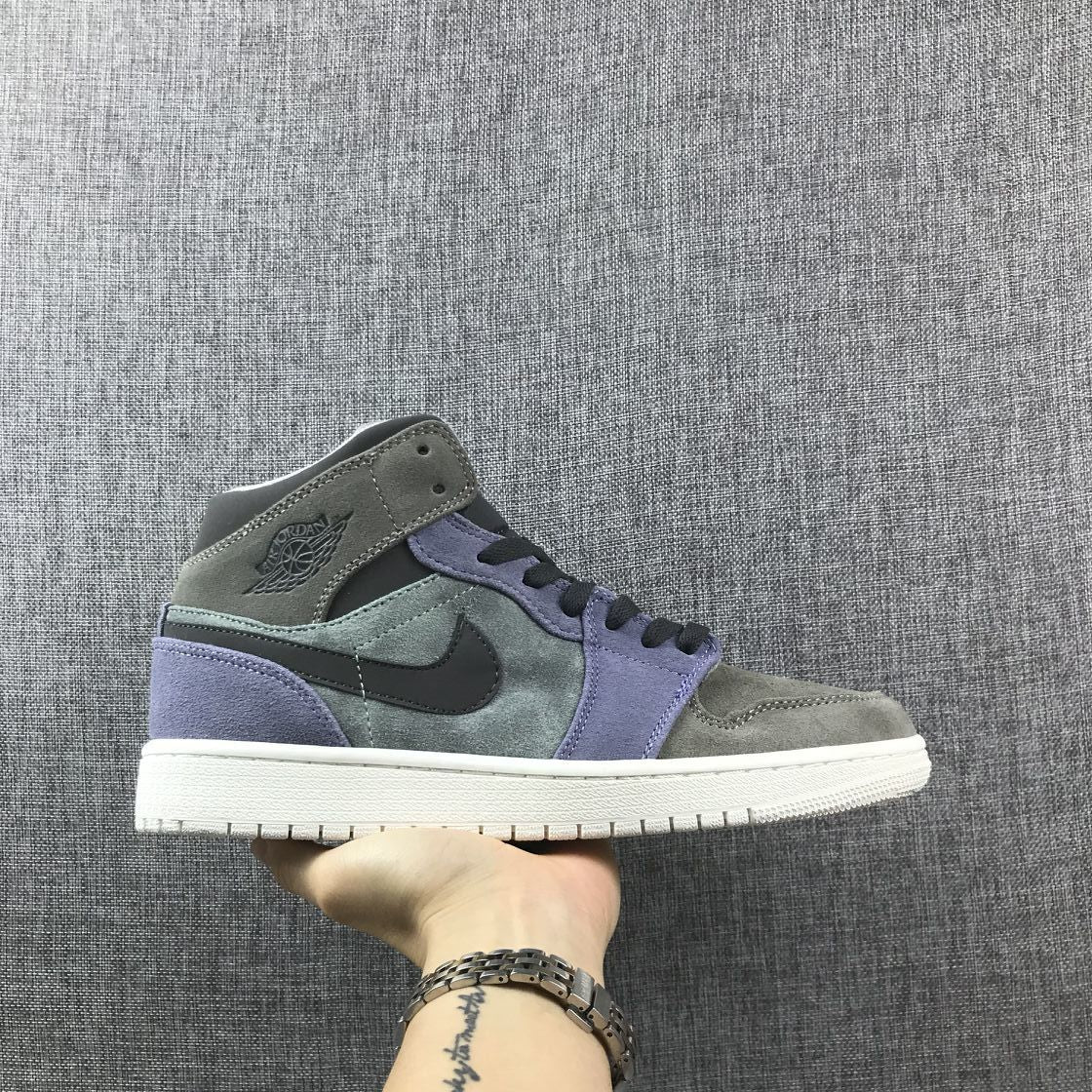 Side view of gray and purple Jordan 1 Mid-style sneakers with black Swoosh, black laces, and white sole.