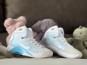 Pair of Nike HD2008 kids high-tops with white laces, pale blue panels, and bright blue accents.