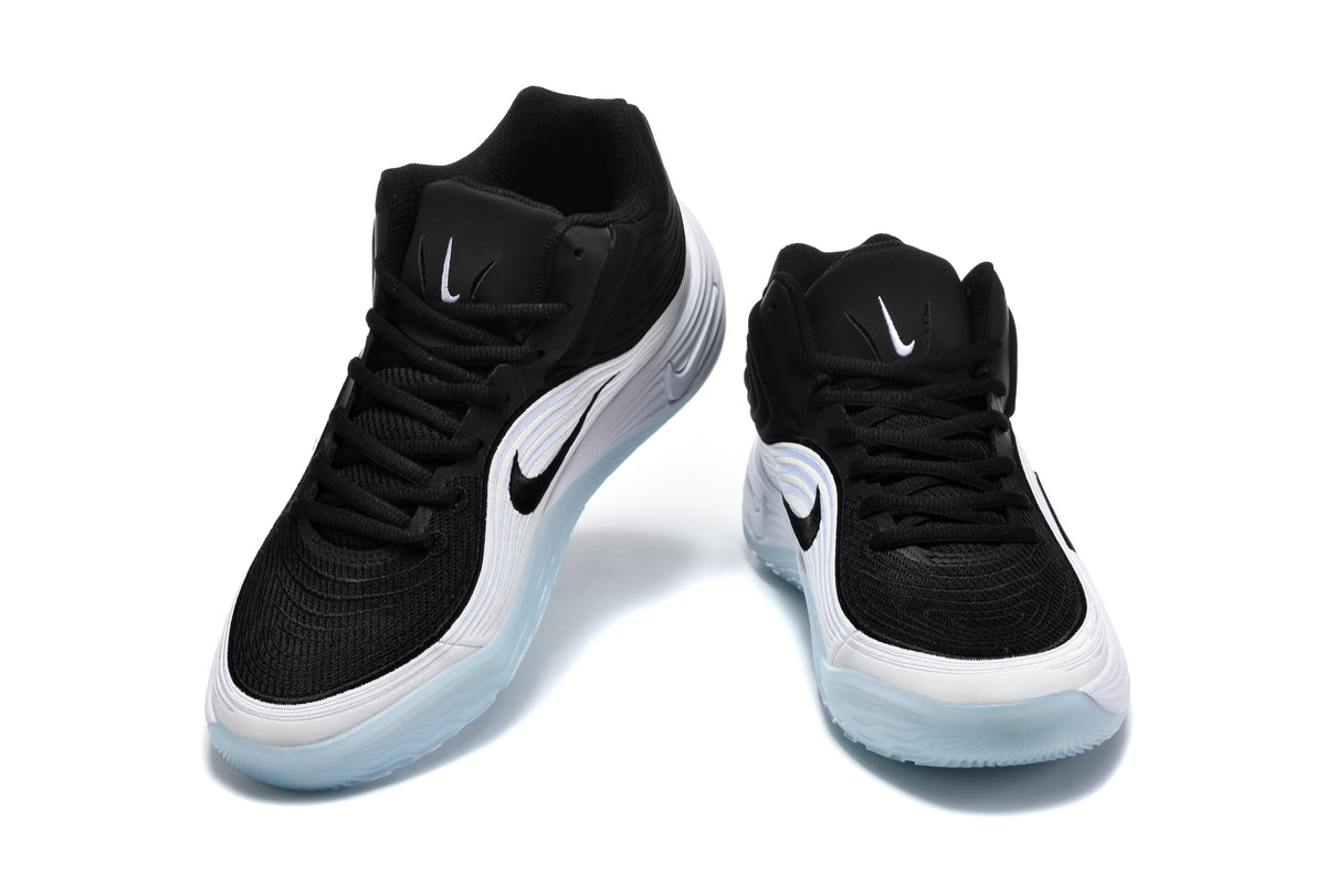 Pair of black and white Nike sneakers shown from the front, with translucent light-blue outsoles.