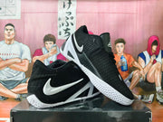Side view of black basketball shoes with white side logos and angular white midsole accents