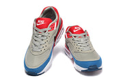 Front view of a pair of Nike Air Max BW sneakers with red tongues and blue toe accents.