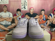 Front view of gray low-top sneakers with matching laces and purple outsoles