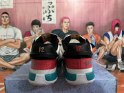 Rear view of white, red, teal, and black Ja basketball shoes with heel details