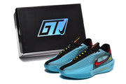 Pair of blue and black sneakers displayed in front of a black GTJ-marked shoe box.