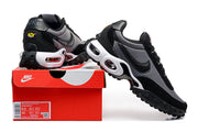 Black and grey Nike sneakers displayed with a red shoe box; the box label shows a sample size.