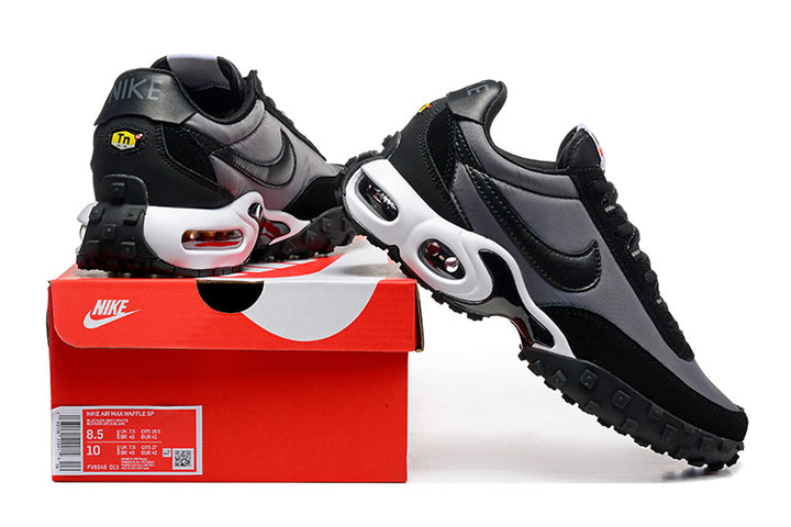 Black and grey Nike sneakers displayed with a red shoe box; the box label shows a sample size.